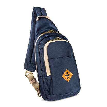 The Daytripper large smell proof crossbody bag in navy blue displayed on a flat surface, exhibiting its overall design.