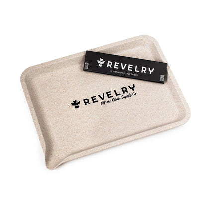 Visual of the items displayed around the Revelry rolling kit, illustrating accessories for a smoking setup on a table.