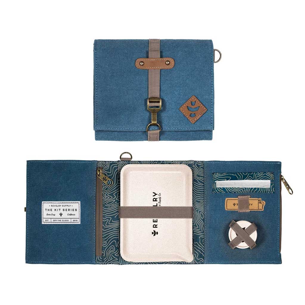 Flat lay of the Revelry all-in-one smell-proof rolling kit, opened to show contents including rolling papers and weed storage.