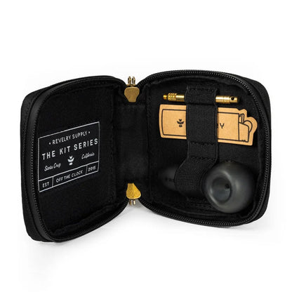 Lifestyle image of the black Revelry PIPE KIT TRAVELER alongside smoking accessories on a table.