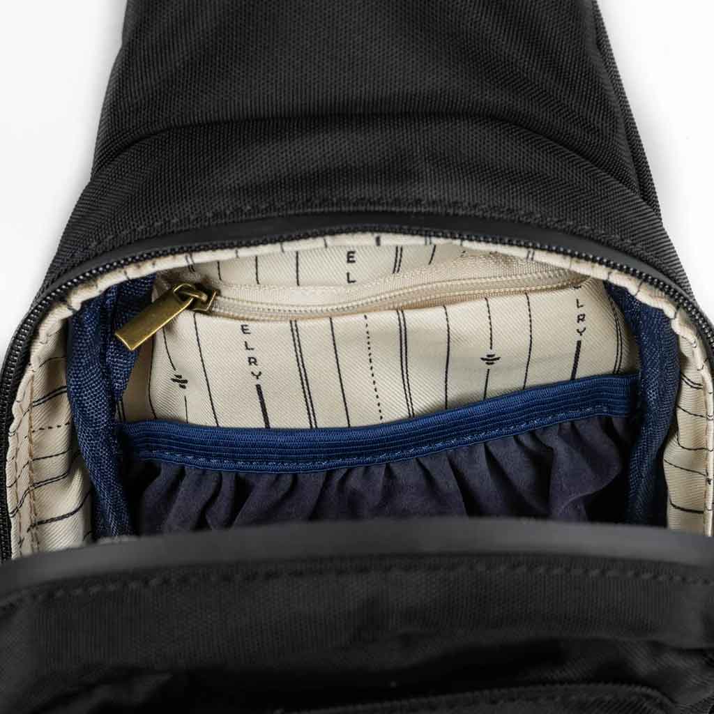 A black Revelry Daytripper Large smell proof crossbody bag.