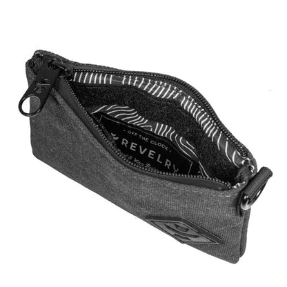 Opened black Revelry The Mini Broker stash bag displaying interior and pockets on a plain background.