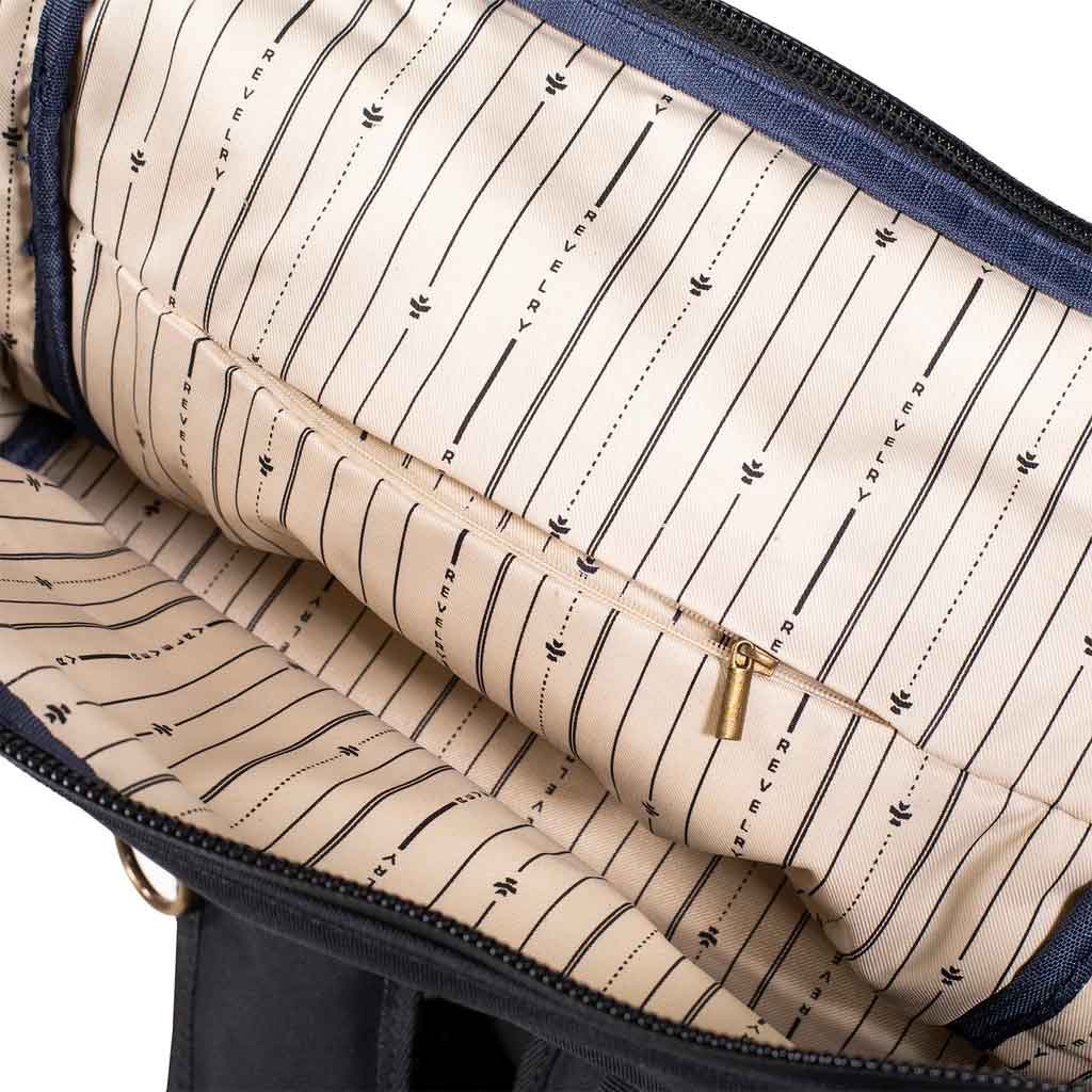 Black Revelry Supply Drifter Backpack laid flat, showcasing the fabric texture and interior organization.