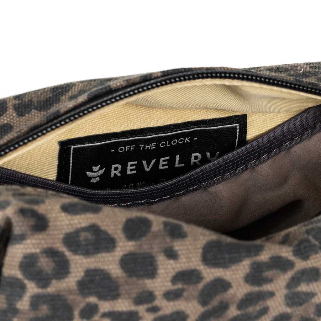 Leopard Revelry Supply The Cache Mini Smell Proof Toiletry Kit displayed with toiletries inside.