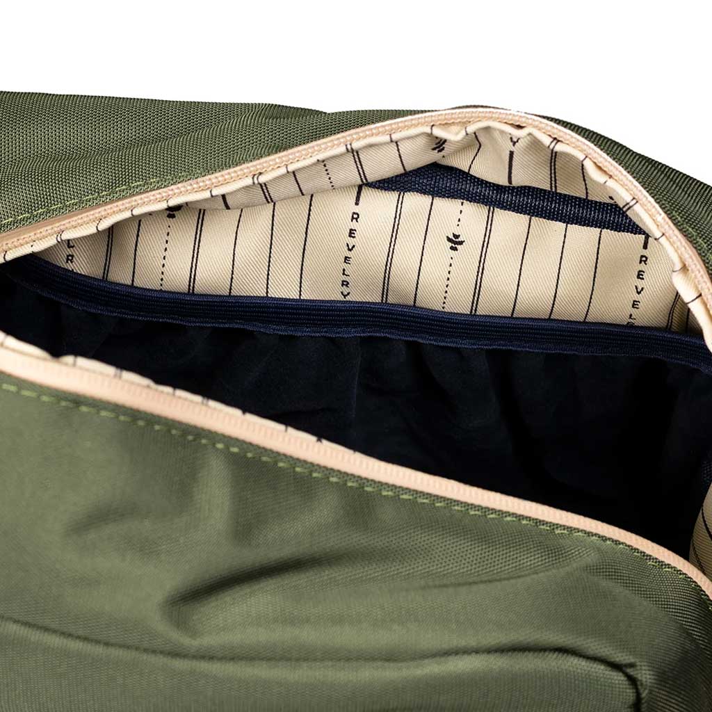 Open view showing the interior compartments of the green Revelry Supply Stowaway kit.