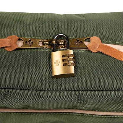 Close-up view of the zipper and fabric texture of the green Revelry Supply toiletry kit.
