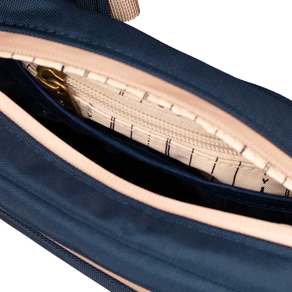 Side view of the Navy Blue Companion Smell Proof Crossbody Bag highlighting the adjustable strap.