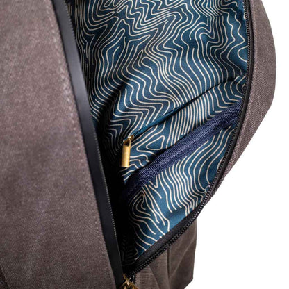 Sage Explorer Smell Proof Backpack standing upright against a plain background, showcasing its spacious design and zippered compartments.